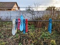 Multicolored clothespins hang on a wire in nature Royalty Free Stock Photo