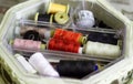 multicolored coils of thread, a centimeter, needles lying in a round box Royalty Free Stock Photo