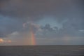 multicolored, colored rainbow after the rain hanging over the sea a