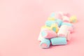 Multicolored colored vibrant marshmallows on a pink background. the concept of childhood