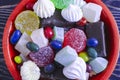 Multicolored confectionery cakes Bizet marmalade sweets in a bowl on a wooden background