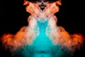 Multicolored curling smoke rising upwards in a pillar, red blue vapor twisting into abstract shapes and patterns on a black