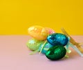 Multicolored decorative Easter eggs decorated with sequins on a color background Royalty Free Stock Photo