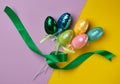 Multicolored decorative Easter eggs decorated with sequins on a color background Royalty Free Stock Photo