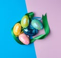 Multicolored decorative Easter eggs decorated with sequins on a color background Royalty Free Stock Photo