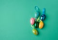 Multicolored decorative Easter eggs decorated with sequins on a green background Royalty Free Stock Photo