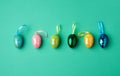 Multicolored decorative Easter eggs decorated with sequins on a green background Royalty Free Stock Photo
