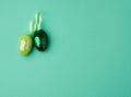Multicolored decorative Easter eggs decorated with sequins on a green background Royalty Free Stock Photo