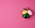 Multicolored decorative Easter eggs decorated with sequins on a pink background Royalty Free Stock Photo