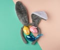 Multicolored decorative Easter eggs decorated with sequins and rabbit mask on the head with ears Royalty Free Stock Photo