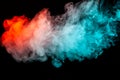 Multicolored dense illuminated smoke rolling from blue to red along substance molecules swirls on a black background, scattering
