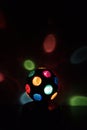 Multicolored Disco-ball lamp in a black backgound