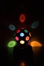 Multicolored Disco-ball lamp in a black backgound