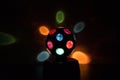 Multicolored Disco-ball lamp in a black background