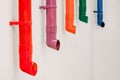 Multicolored downspouts in a row on the wall. Royalty Free Stock Photo