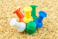Multicolored draw-pins stick into cork board Royalty Free Stock Photo