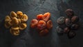 Multicolored dried apricots on a gray stone