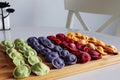 Multicolored dumplings are on a wooden board