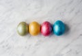 Multicolored dyed Easter eggs on white marble background