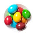 Multicolored Easter eggs, rainbow colored Paschal eggs in a white bowl