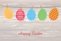 Multicolored Easter eggs with wings hang on a rope on clothespin