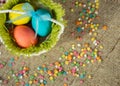 Multicolored eggs in easter festive basket on canvas napkin