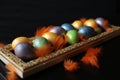 Multicolored eggs painted for Easter lie on a golden tray