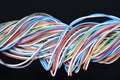 Multicolored electrical cable on dark background Royalty Free Stock Photo