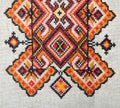 Multicolored embroidered element on linen cotton threads