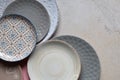 Multicolored empty ceramic plates and bowls on a marble background. Table setting. Shabby chic or retro style. Copy space. Mock up Royalty Free Stock Photo