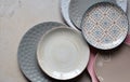 Multicolored empty ceramic plates and bowls on a marble background. Table setting. Shabby chic or retro style. Copy space. Mock up