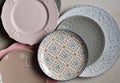 Multicolored empty ceramic plates and bowls on a marble background. Table setting. Shabby chic or retro style. Copy space. Mock up Royalty Free Stock Photo