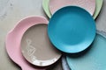 Multicolored empty ceramic plates and bowls on a marble background. Table setting. Shabby chic or retro style. Copy space. Mock up Royalty Free Stock Photo