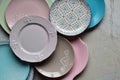 Multicolored empty ceramic plates and bowls on a marble background. Table setting. Shabby chic or retro style. Copy space. Mock up Royalty Free Stock Photo