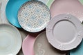 Multicolored empty ceramic plates and bowls on a marble background. Table setting. Shabby chic or retro style. Copy space. Mock up Royalty Free Stock Photo