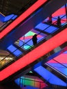 Multicolored Escalators and People at the Shopping Mall Royalty Free Stock Photo