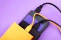 Multicolored external portable hard disk drives isolated on violet Royalty Free Stock Photo
