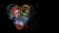 Multicolored fireworks heart in black sky, copy space