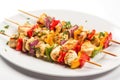 multicolored fish skewers on a clean white plate