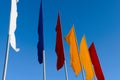 Multicolored flags against a blue sky Royalty Free Stock Photo