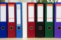 Multicolored folders standing on a shelf Royalty Free Stock Photo