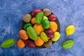 Multicolored fresh fruits in flat plate on sapphirine background