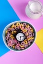 Breakfast cereals in the ceramic bowl, jug of milk and alarm clock Royalty Free Stock Photo