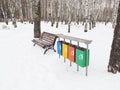 Multicolored garbage can garbage container for municipal waste and industrial waste, snow, winter, ecology