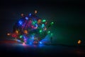 Multicolored garland on a dark background. Christmas