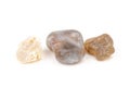 Multicolored gemstones, tumbled minerals. Bostwan agate of various sizes on a white background Royalty Free Stock Photo