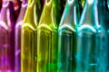 Multicolored glass bottles on the shelf in the store. Royalty Free Stock Photo