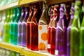 Multicolored glass bottles on the shelf in the store. Royalty Free Stock Photo