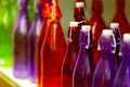 Multicolored glass bottles on the shelf in the store. Royalty Free Stock Photo