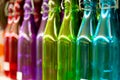 Multicolored glass bottles on the shelf in the store. Royalty Free Stock Photo